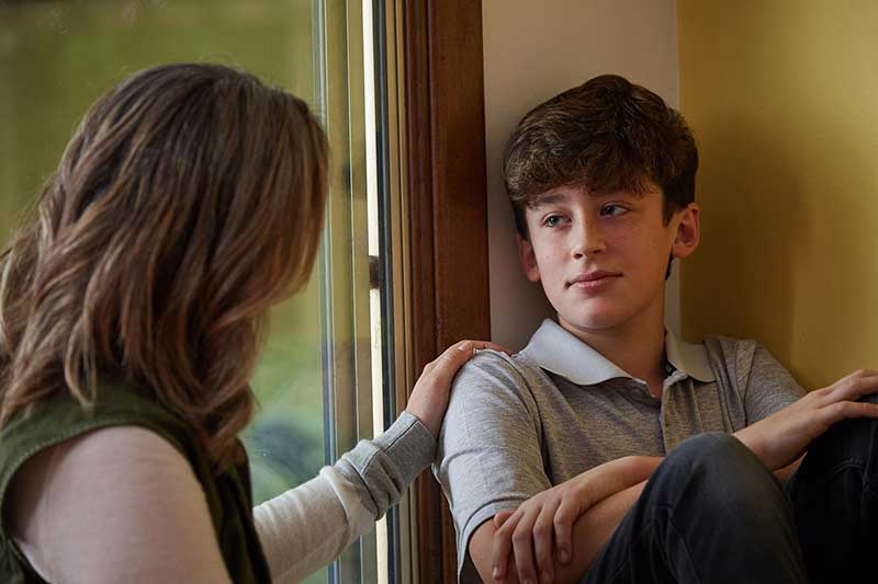 mom talking to child in living room