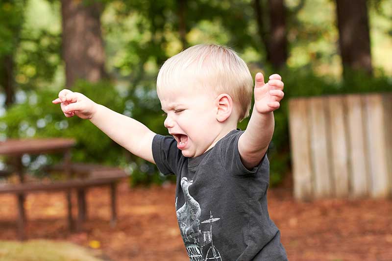 child having a tantrum outside of home