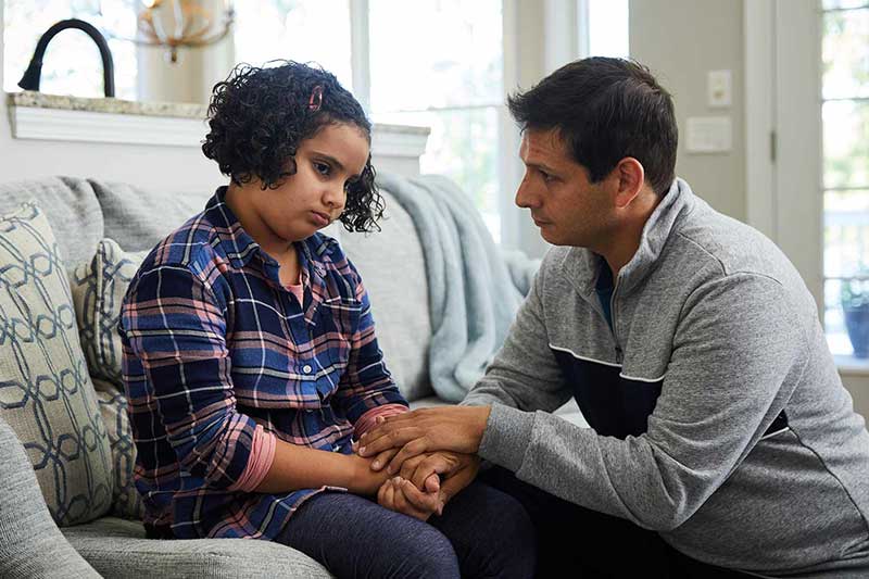 Dad calming down upset girl