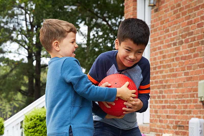 kids fighting over ball while playing