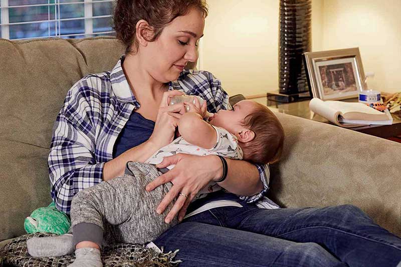 holding bottle nipple in baby's mouth