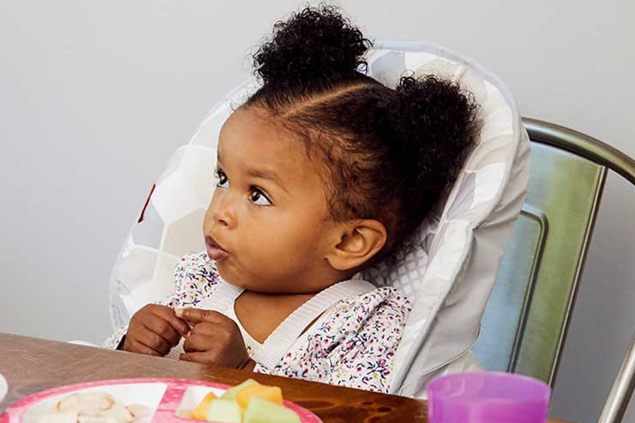 Toddler girl signing to ask for more food