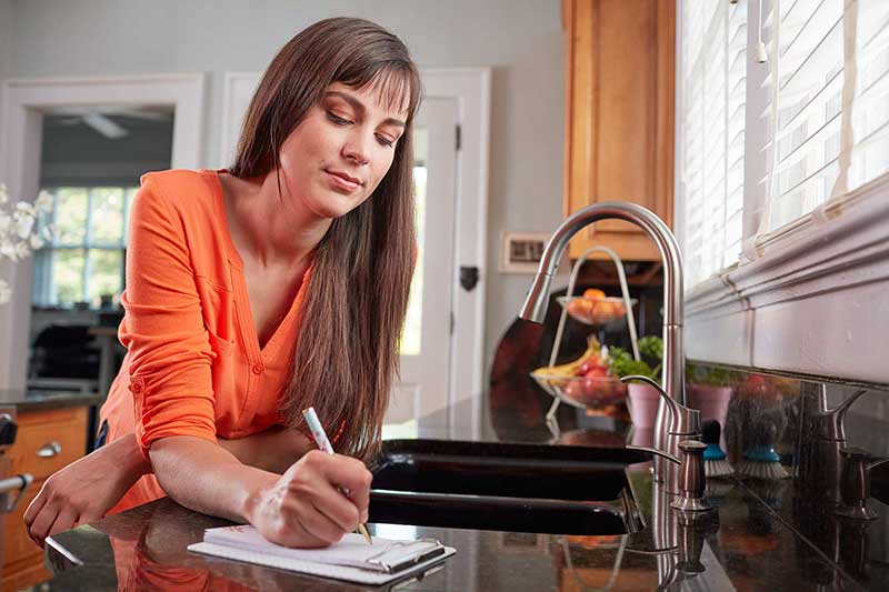 mom writing grocery list