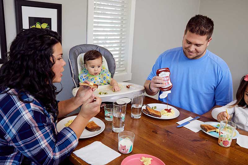 dad adding ketchup to plate