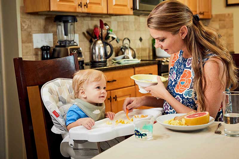 infant eating scrambled eggs