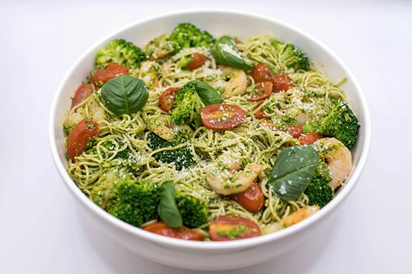 A photograph of the spinach pesto pasta with broccoli and shrimp recipe.