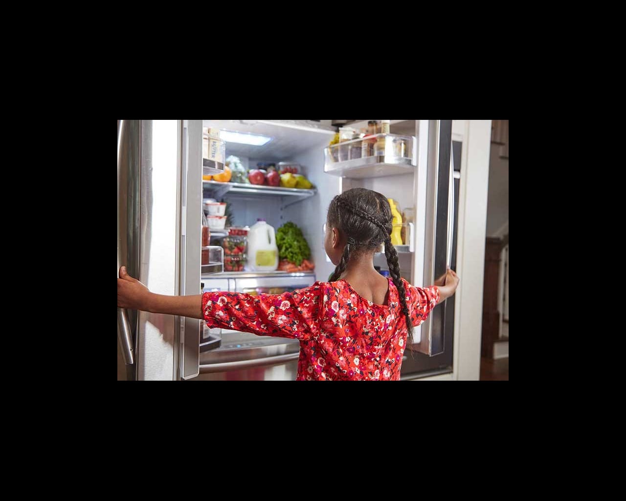 girl looking in fridge