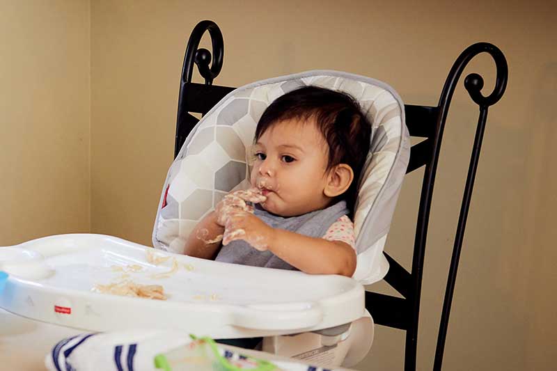 9 month old eating hummus