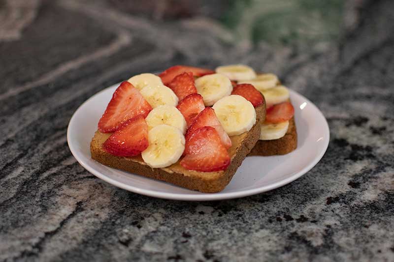 Nut butter toast with strawberries and banana for kids