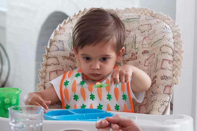 toddler self feeding with utensil