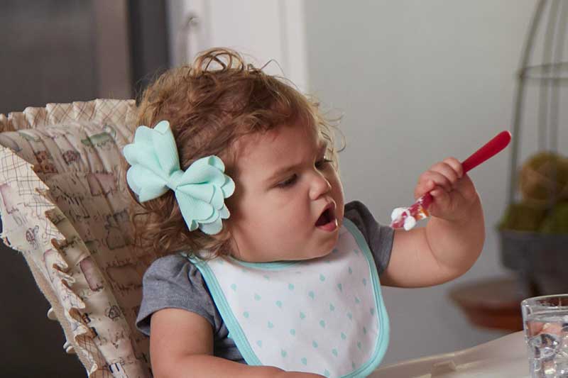 toddler self feeding with utensil