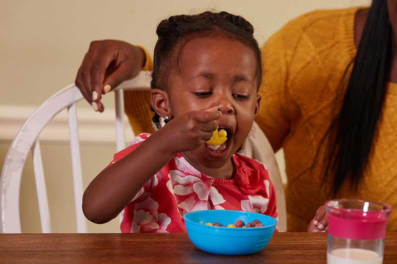 toddler eating sugary cereal