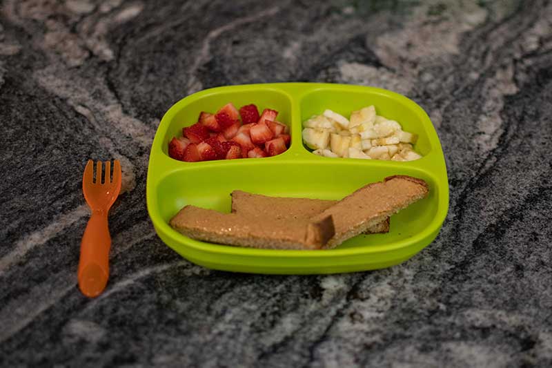 Nut butter toast with strawberries and banana for toddlers