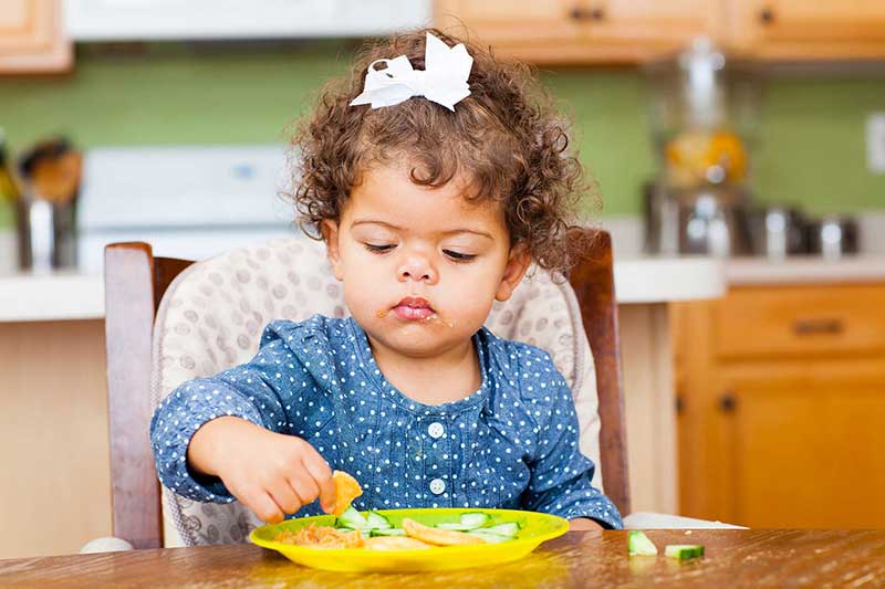 toddler with snack