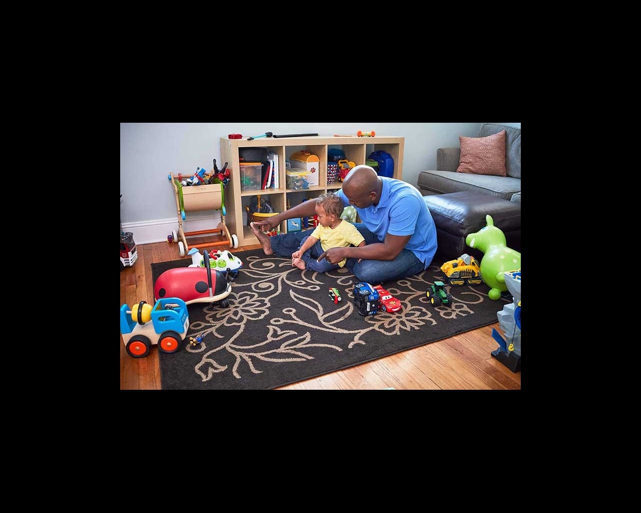 dad and son playing in toy room