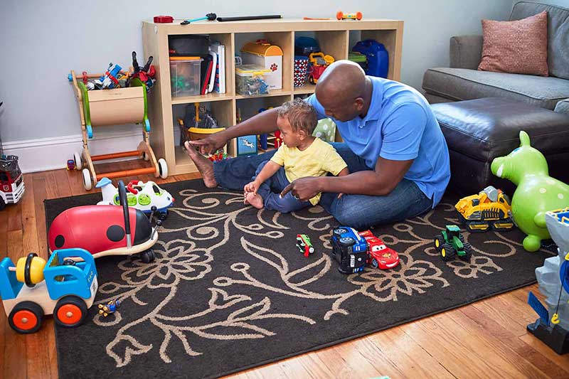 dad and son playing in toy room