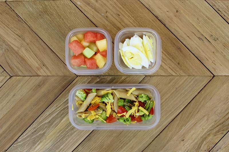 Toddler packed lunch with veggie pasta salad, melon and hard-boiled egg