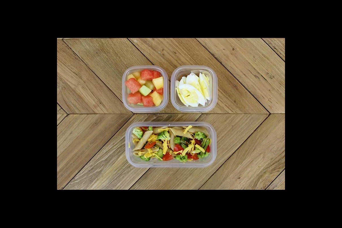 Toddler packed lunch with veggie pasta salad, melon and hard-boiled egg