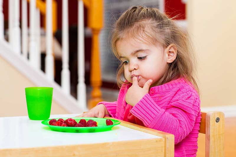 toddler with snack