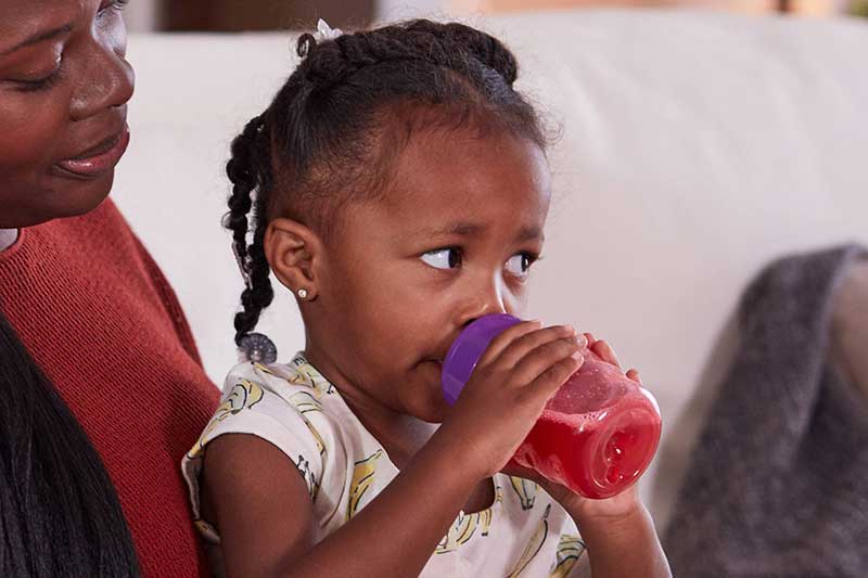 toddler drinking sweet fruit drink