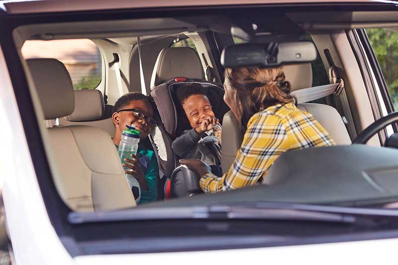 family in car smiling