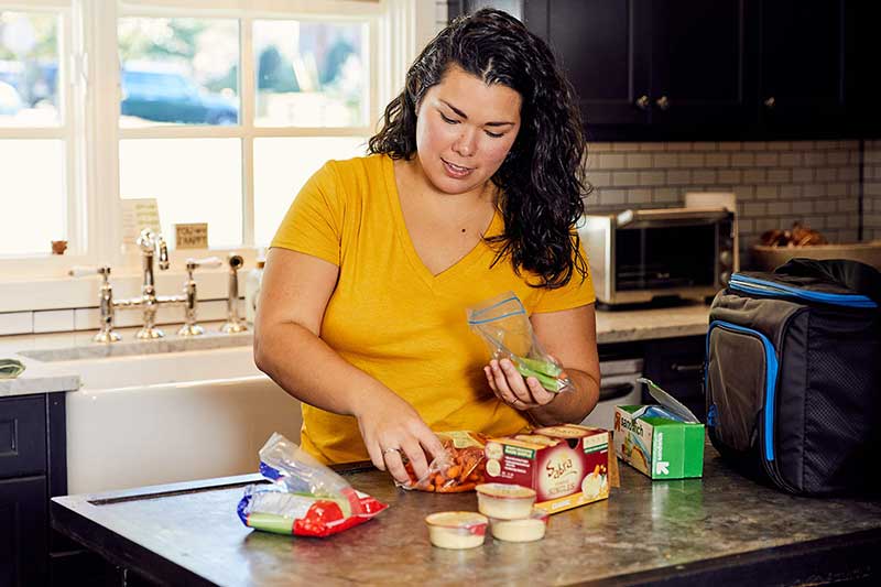 mom packing individual snacks