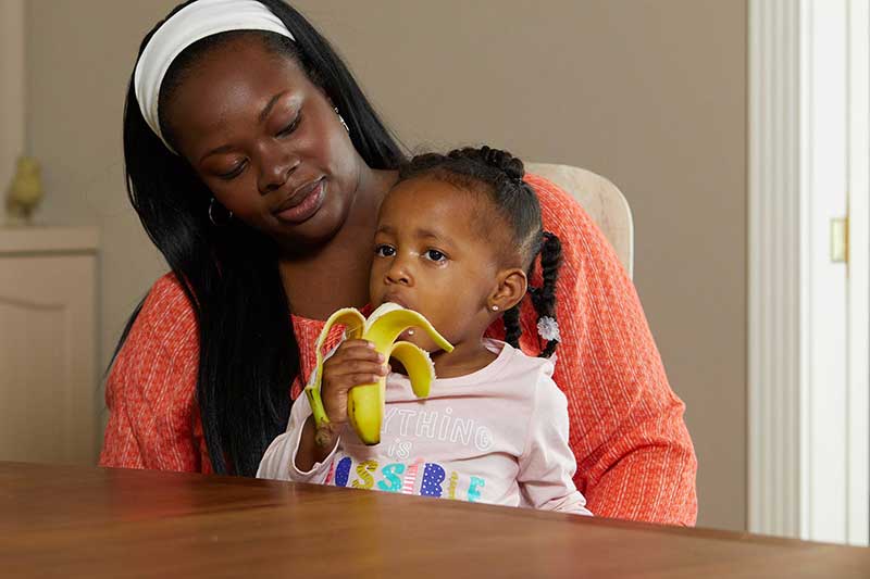 toddler eating a banana