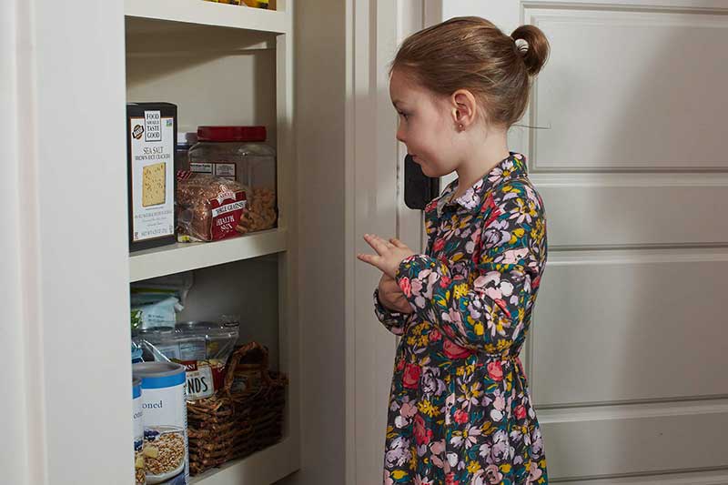 girl looking in pantry