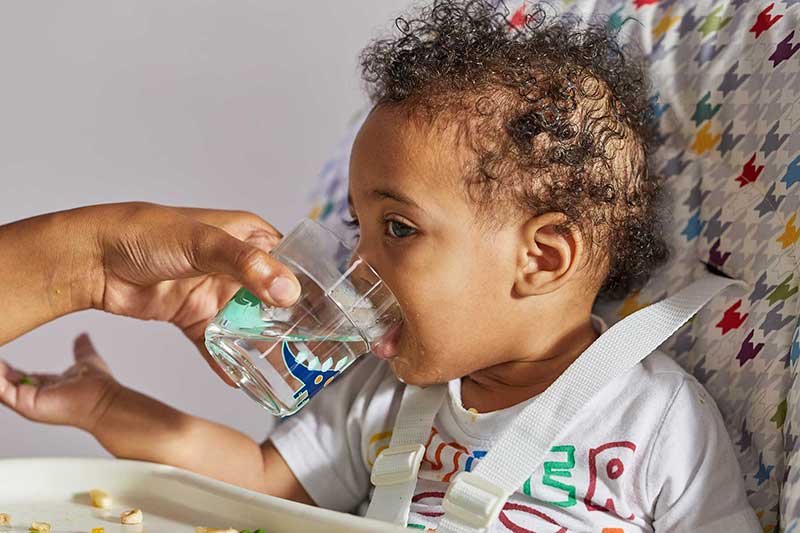 9 month old drinking from cup