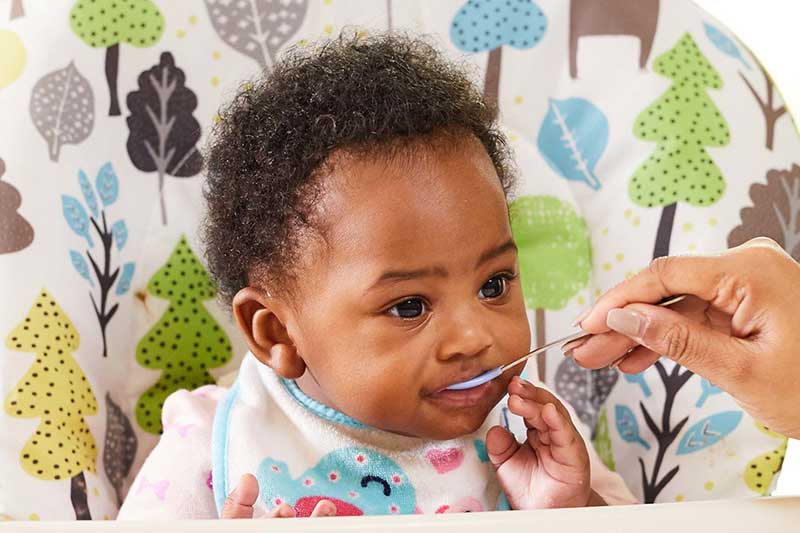 5 month old closing mouth over spoon