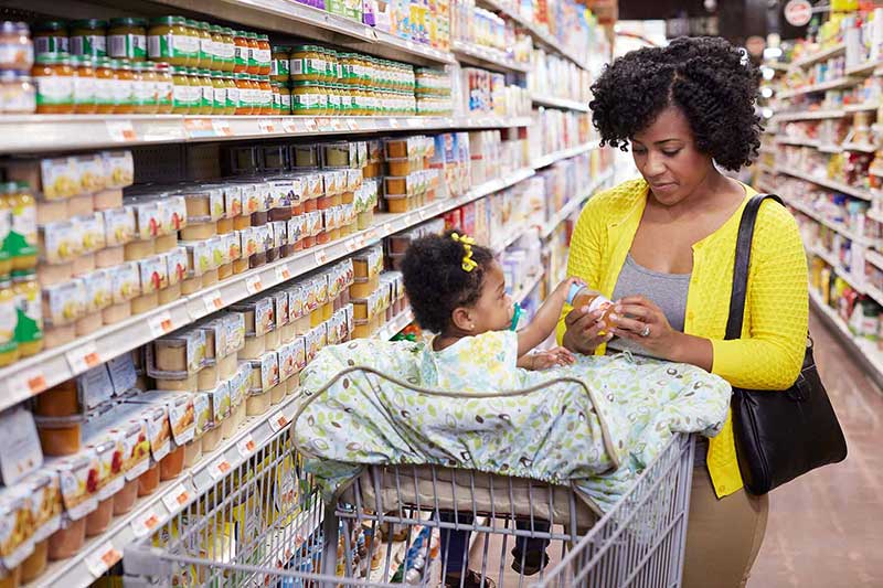 Mom looking ingredients with daughter