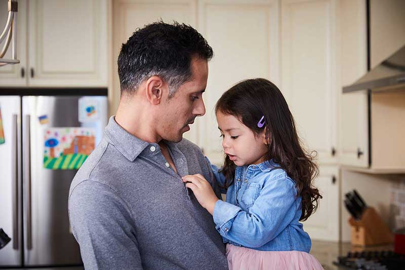 dad holding daughter