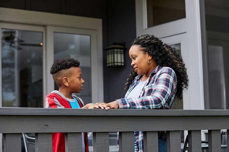 mom talking to son on patio