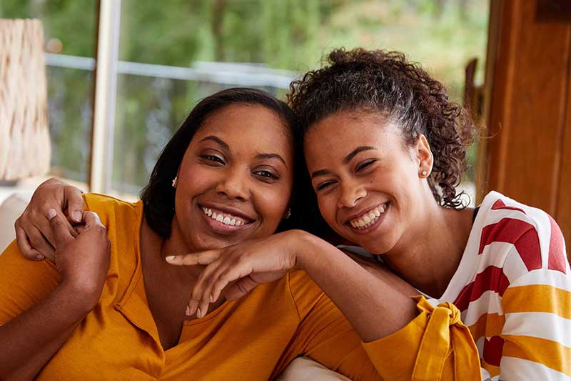 mom and daughter smiling and having fun together