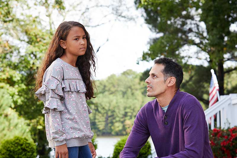 Dad comforting his daughter outside