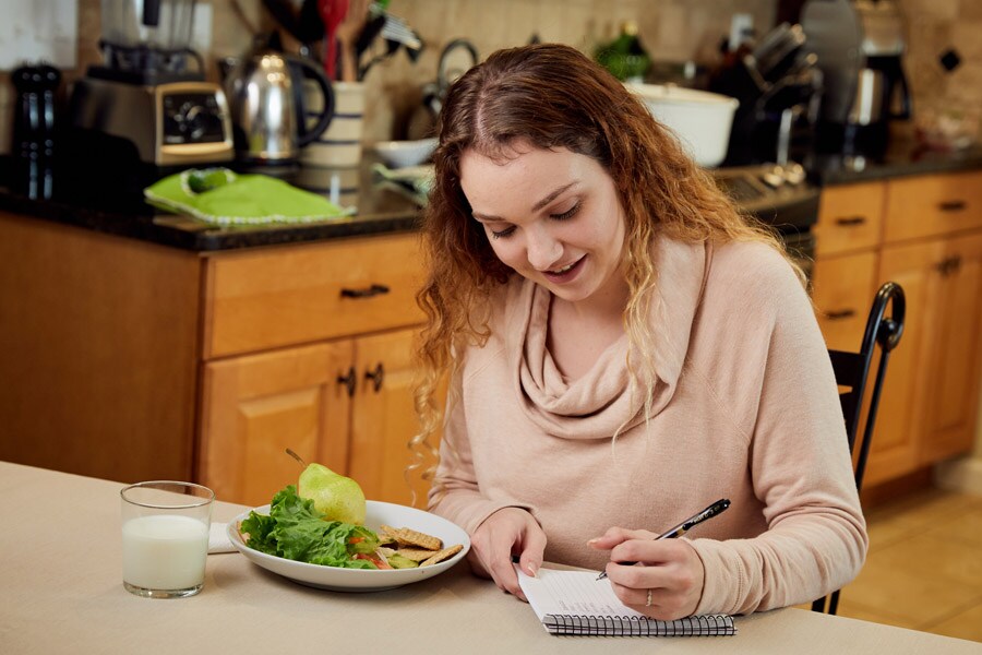 mom writing down wellness goals