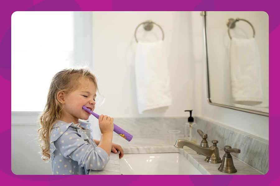 Morning routine with preschool girl brushing her teeth