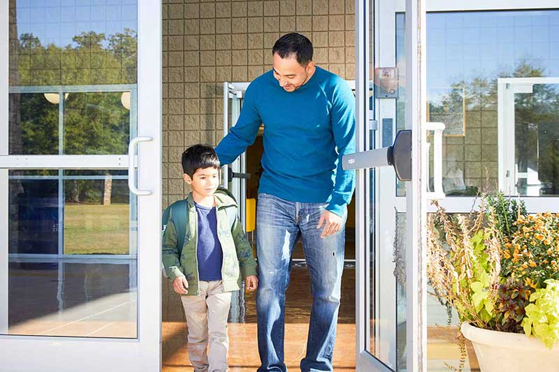 father walking son out of school