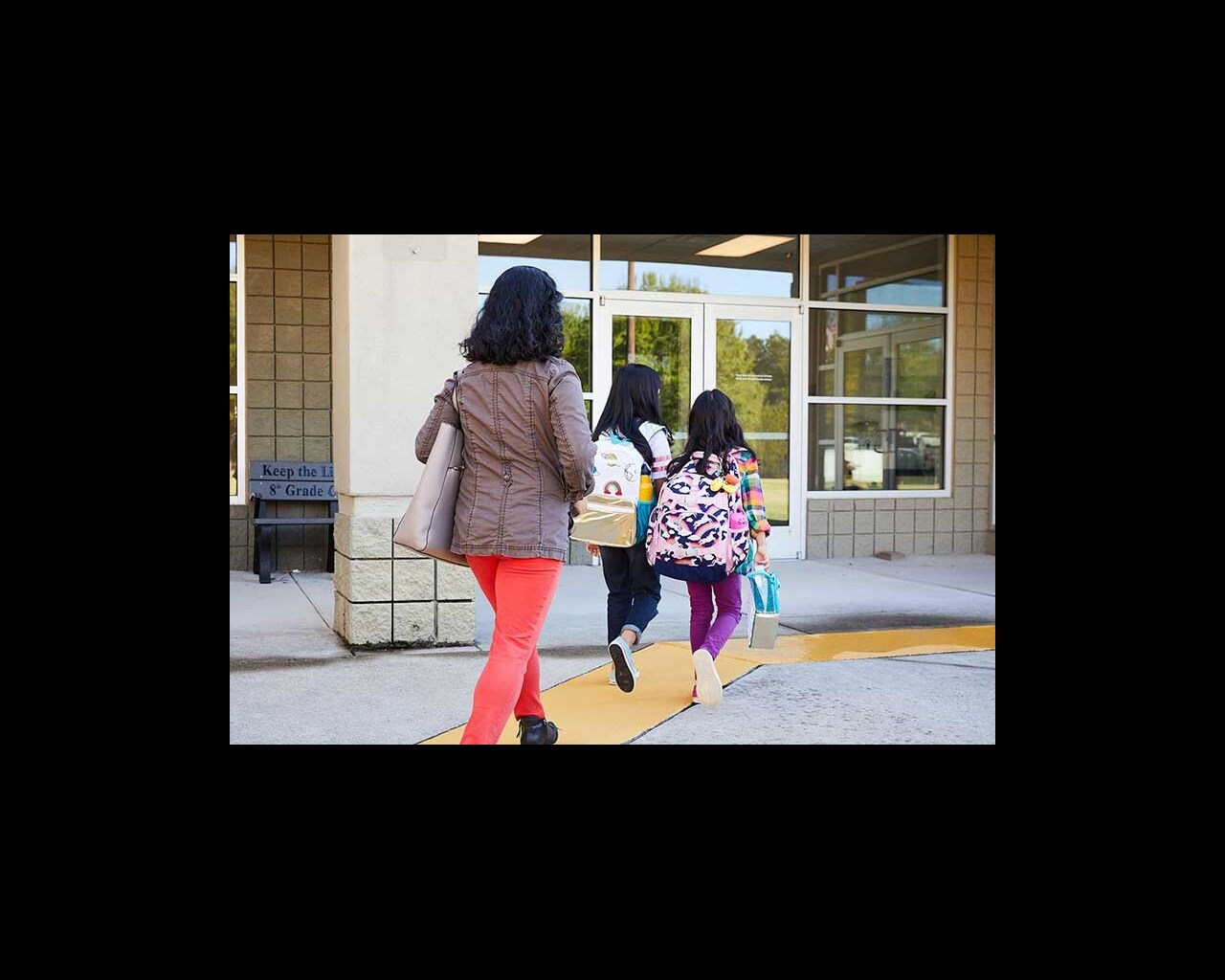mom walking daughters to school