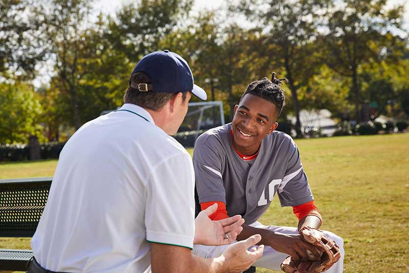 high school baseball playing talking to coach