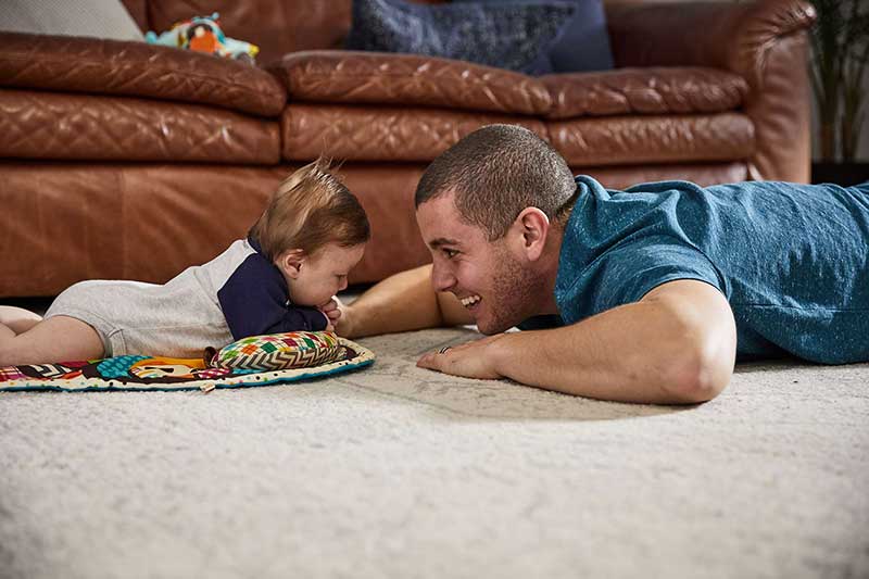 dad and baby doing tummy time