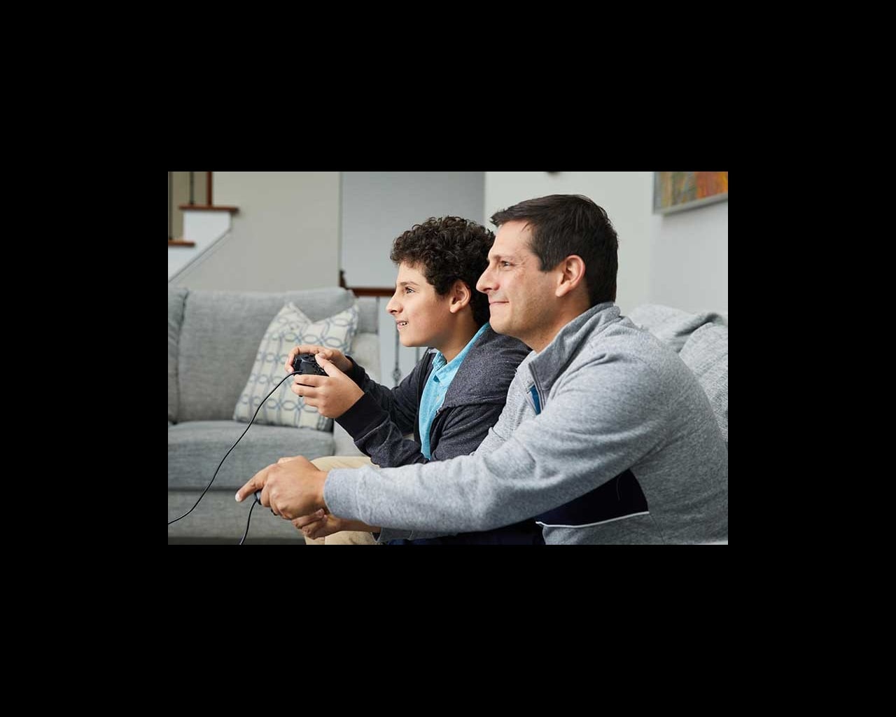dad and son playing video game together