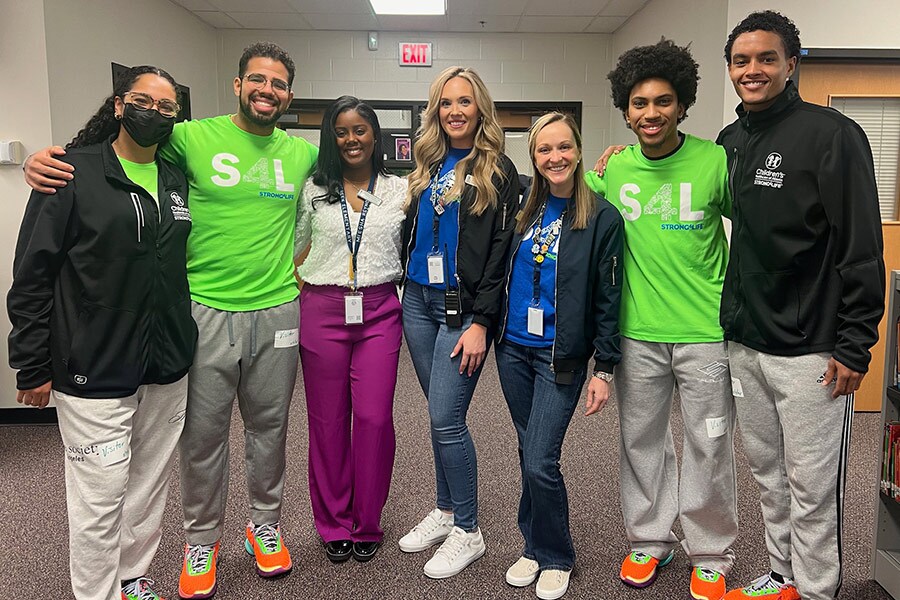 Strong4Life Challenge team members posing with school staff