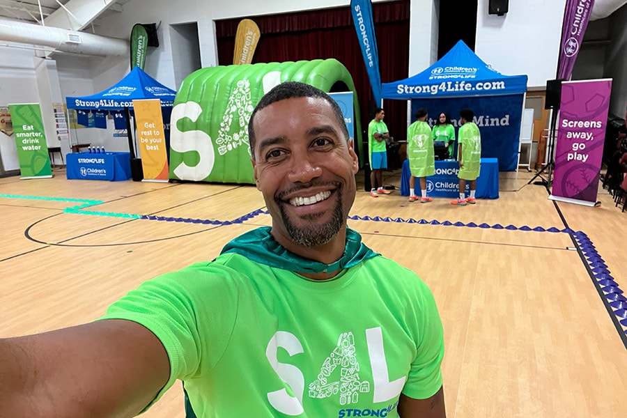 Challenge Team member posing for a selfie in an elementary school gym
