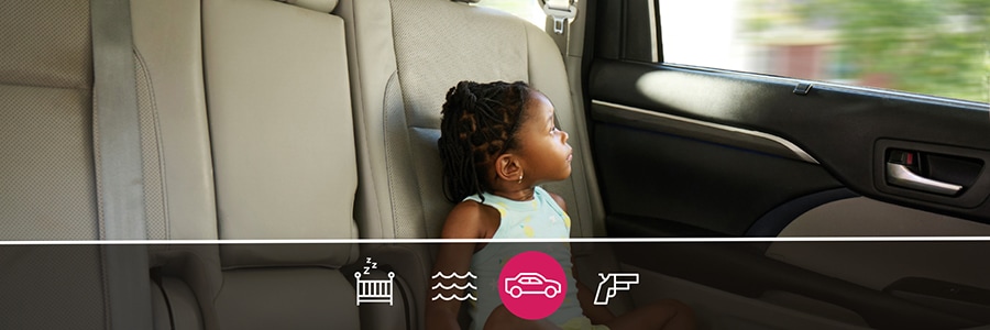 Image of young girl with no seat belt in moving car
