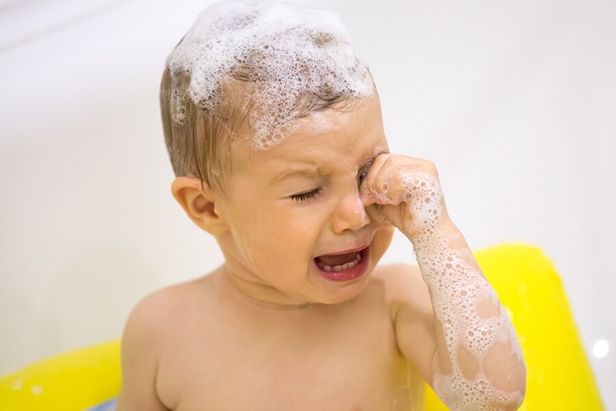 Toddler cries in the tub because they suddenly hate baths.