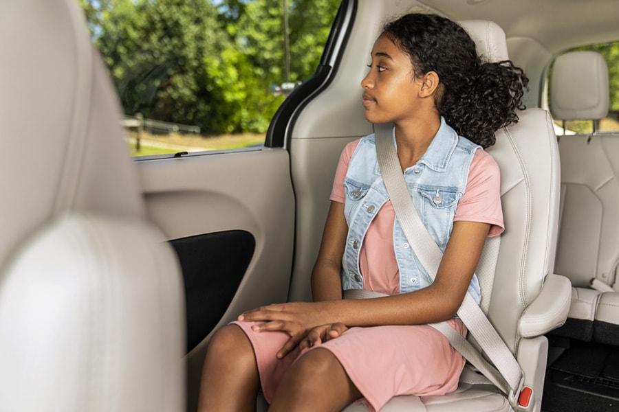 13-year-old girl sitting in car with seat belt securely fastened