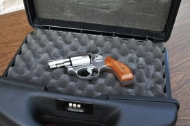 A firearm is safely secured inside of a lockbox
