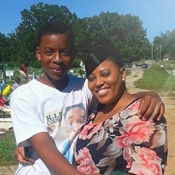 Georgia mom hugging her teenage son who later died because of an unsecured firearm