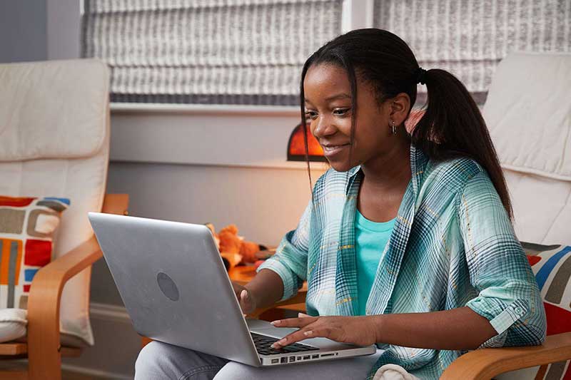 young girl using laptop